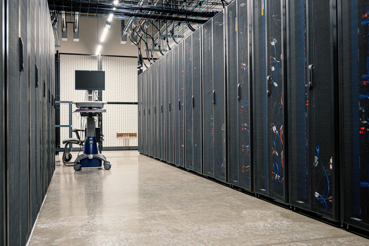 Empty server room aisle with rack-mounted equipment