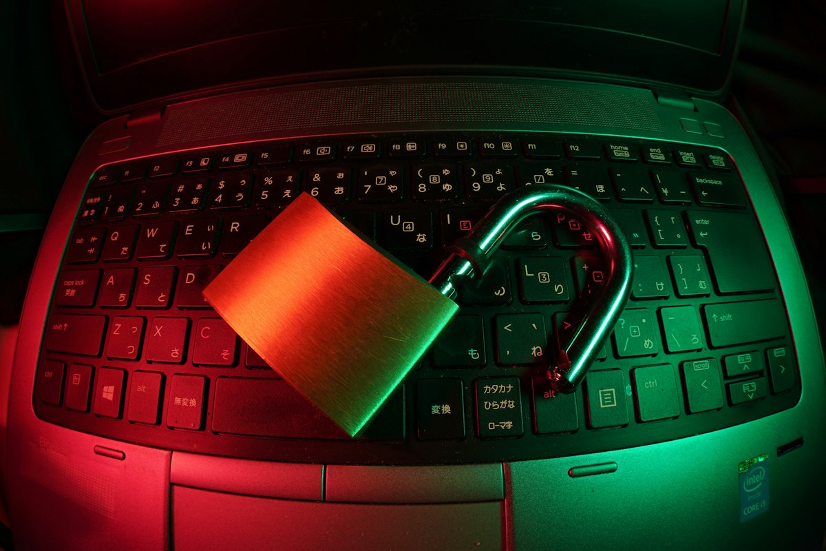 Close-up of a padlock on a laptop keyboard — the first line of defense is your own machine