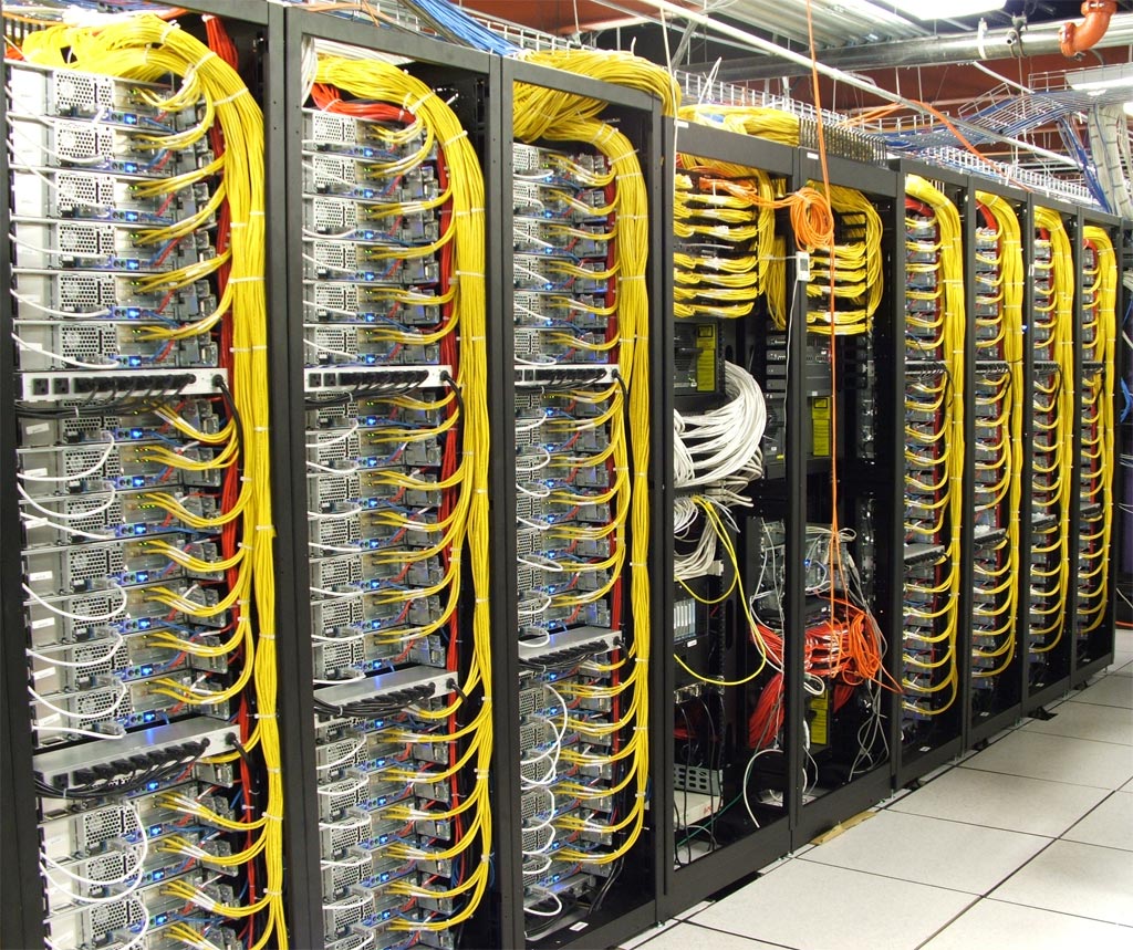 The Emulab research cluster: rows of server racks with dense yellow cabling — the physical reality of running AI infrastructure yourself