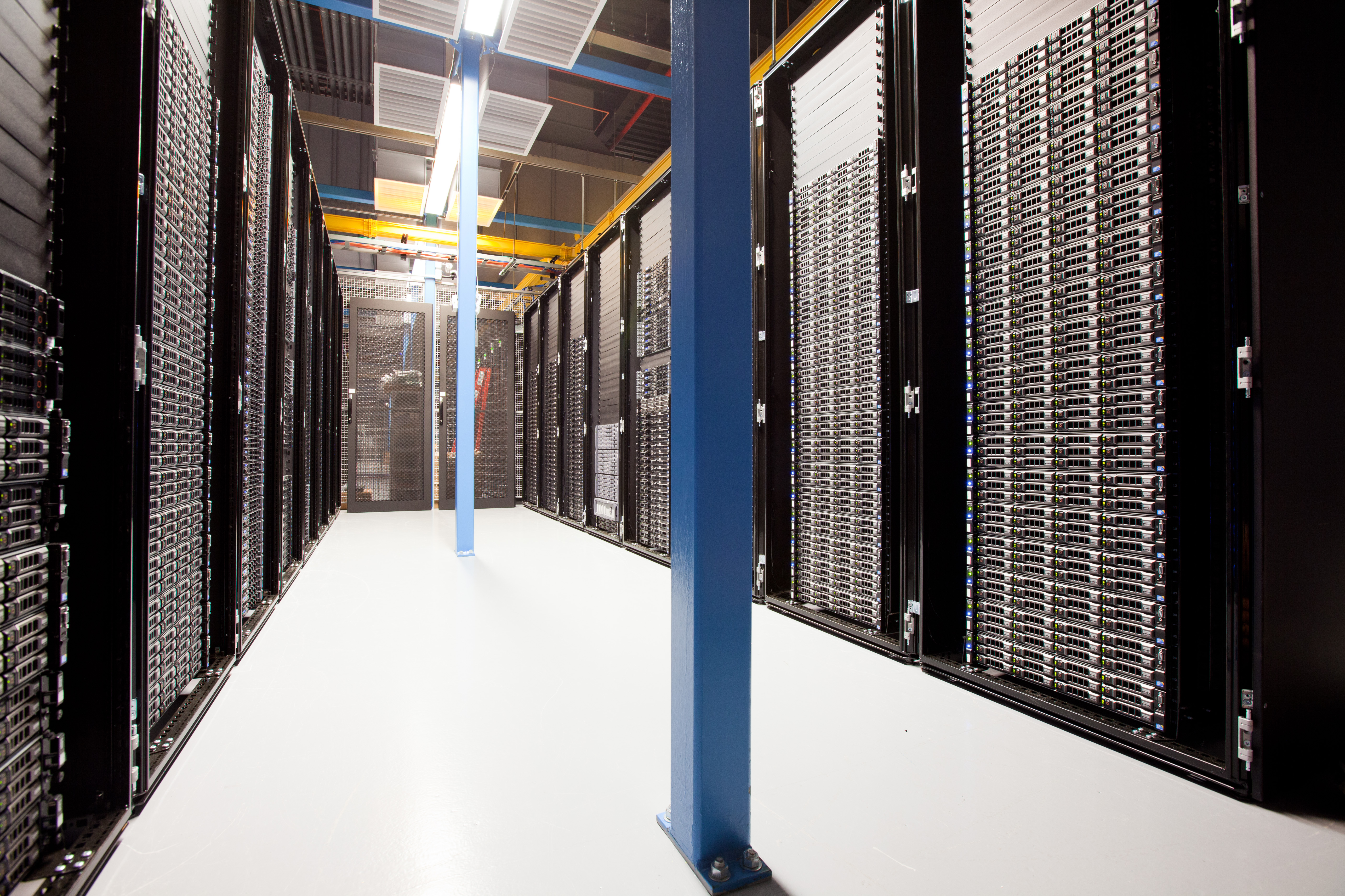 Rows of server racks in a data center corridor — the kind of on-premises infrastructure that keeps agent workloads behind your own firewall
