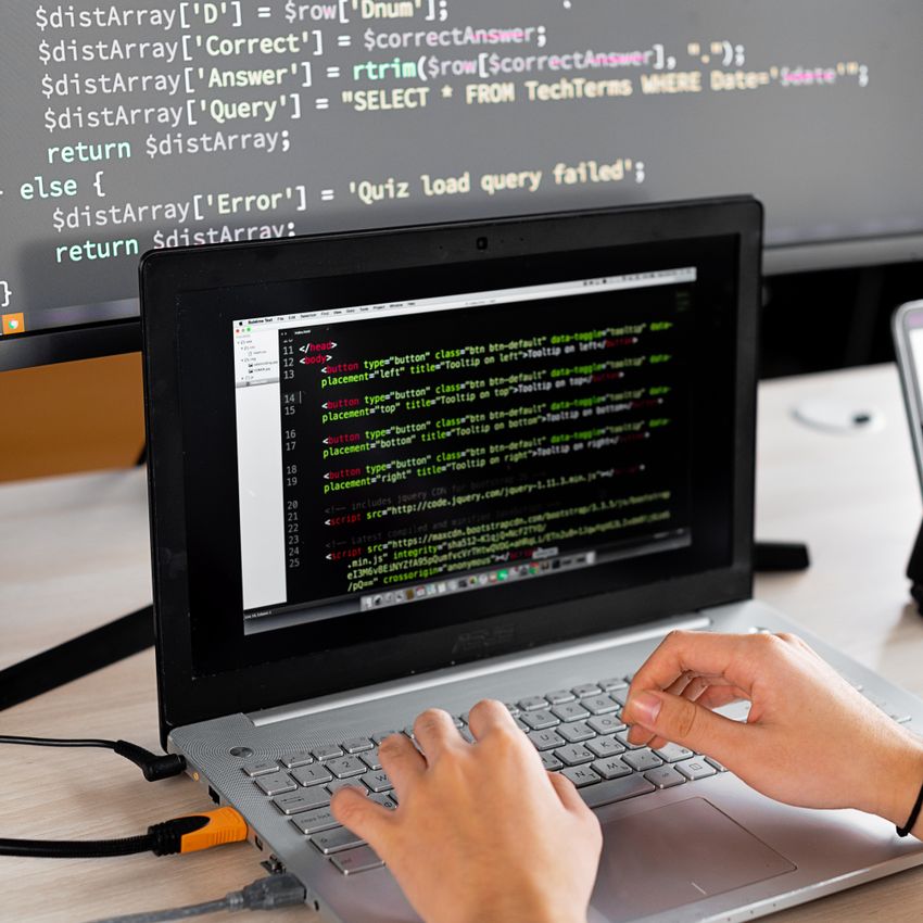 Developer typing code on a laptop — rotating API keys and verifying the gateway after the upgrade