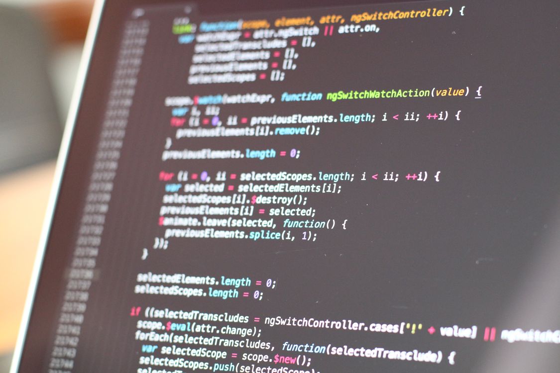 Code on a laptop screen — shrinking tool outputs before the agent sees them keeps token costs under control