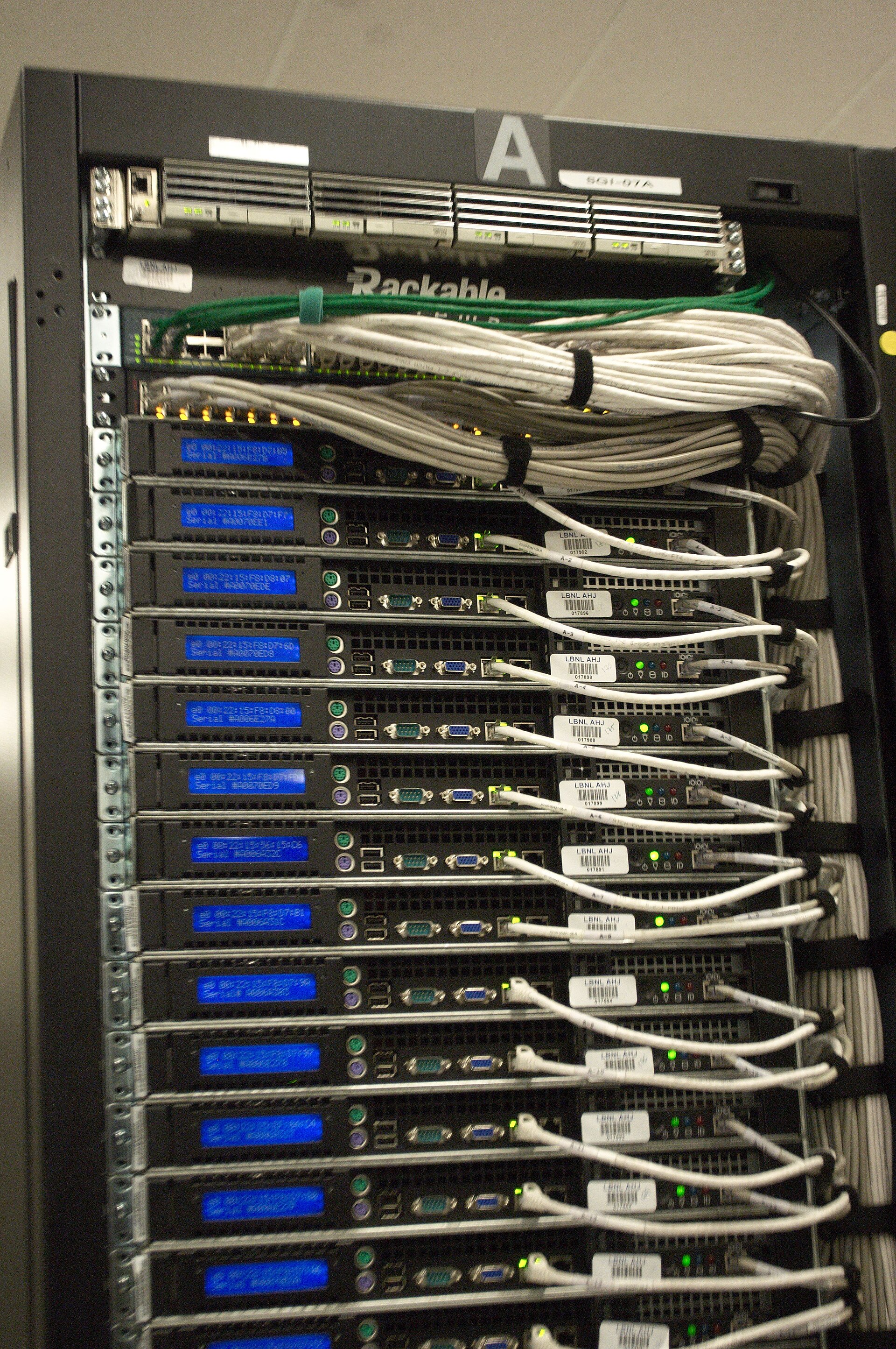 Close-up of network cabling at the rear of a server rack — Sentry observes agent behavior from this network layer, independent of the host the agent runs on