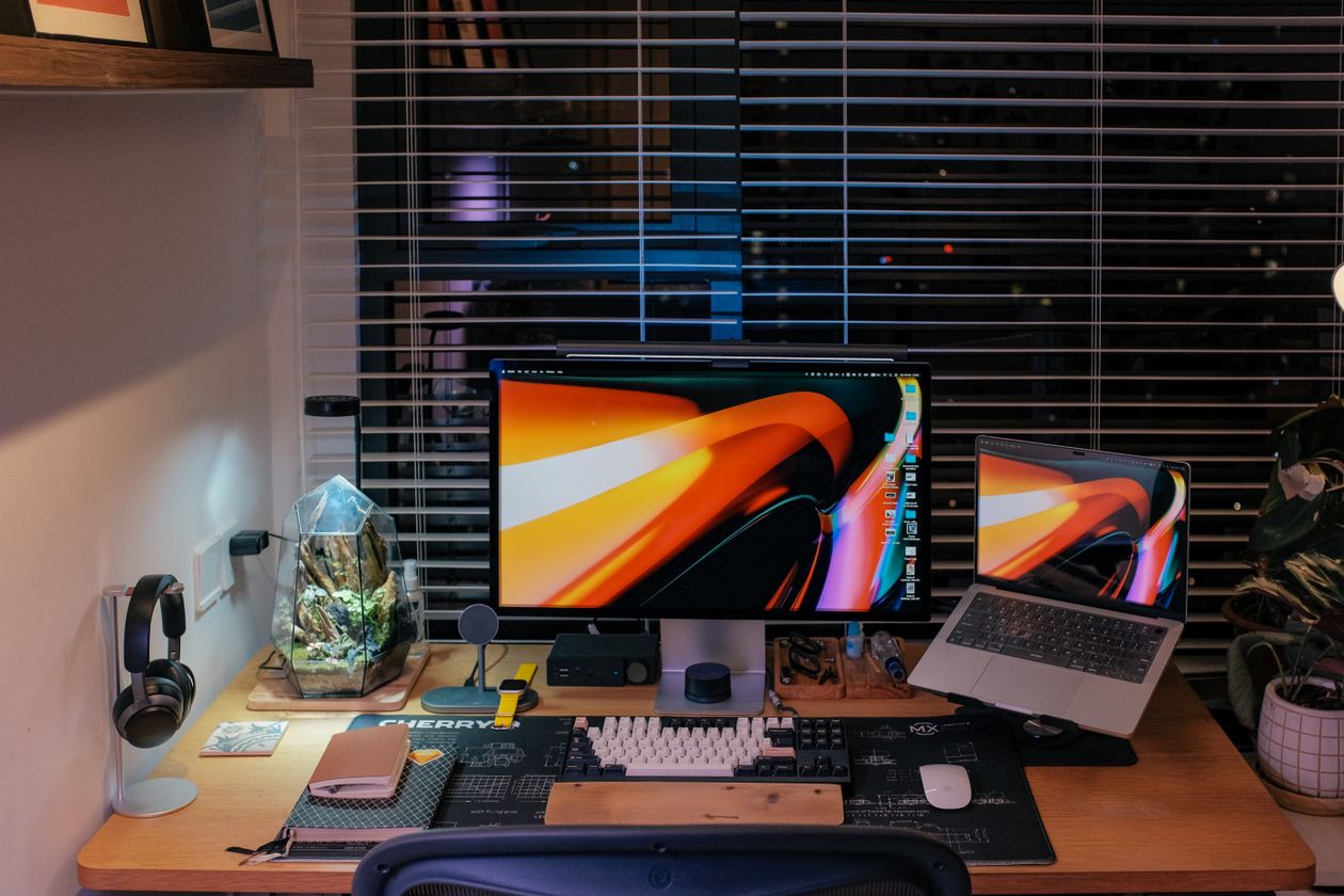 A home workspace at night — always-on local agents trade a per-token cloud bill for electricity and a one-time hardware purchase