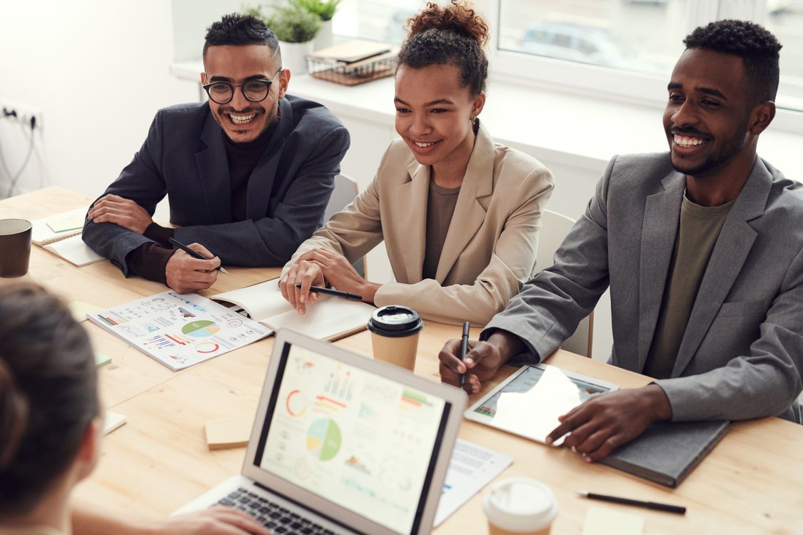 A business team reviewing charts and plans around a table