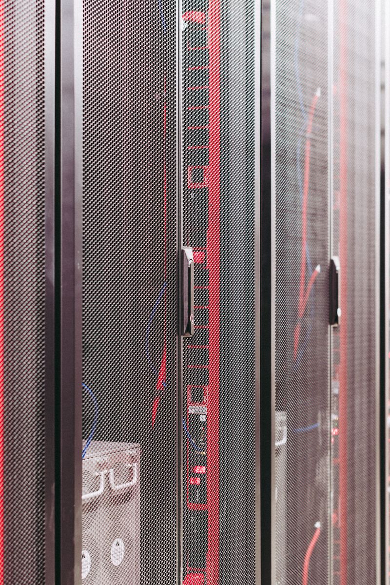 Rows of server racks in a data center — where self-hosted automation servers concentrate the secrets attackers want