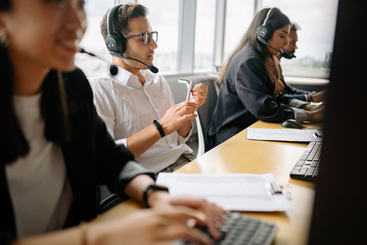 Support team members with headsets working at their desks