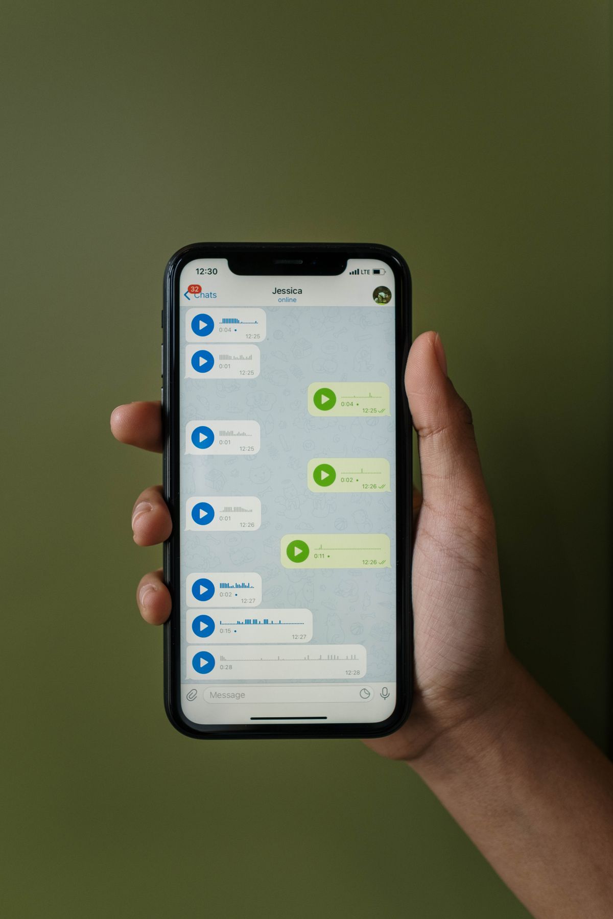 A smartphone showing a WhatsApp conversation with voice messages